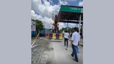 assam  protest turns violent as residents demolish toll plaza wall